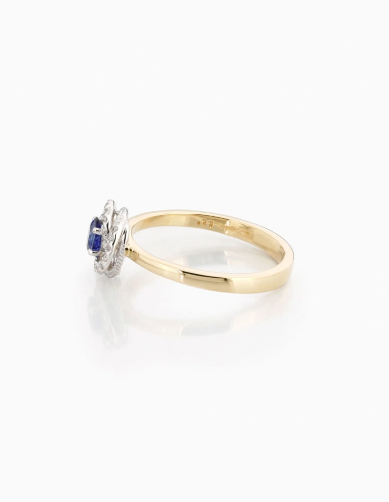 Side view of an 18ct yellow gold dress ring with a sapphire and diamond swirl cluster
