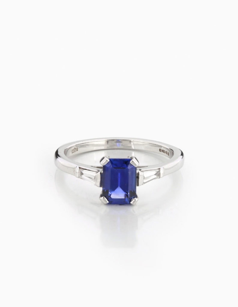 18ct white gold dress ring with an emerald-cut tanzanite centre stone and tapered baguette diamond shoulders