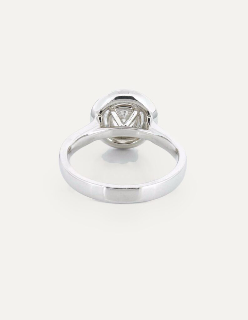 Back view of a platinum halo ring showing the diamond-set shoulders and hallmark