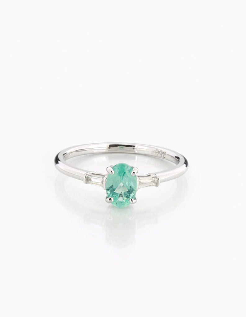 18ct white gold three-stone ring with a central emerald-cut Paraiba tourmaline flanked by tapered baguette diamonds