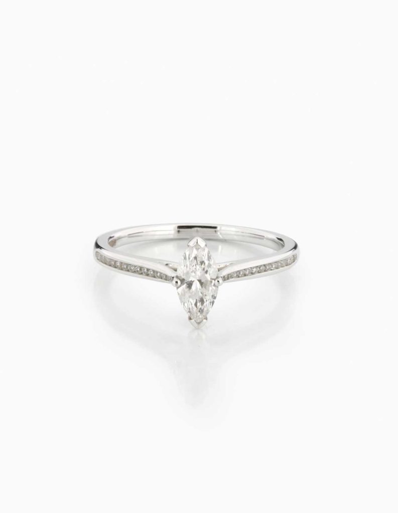 Platinum solitaire ring with a marquise-cut diamond and pave diamond shoulders