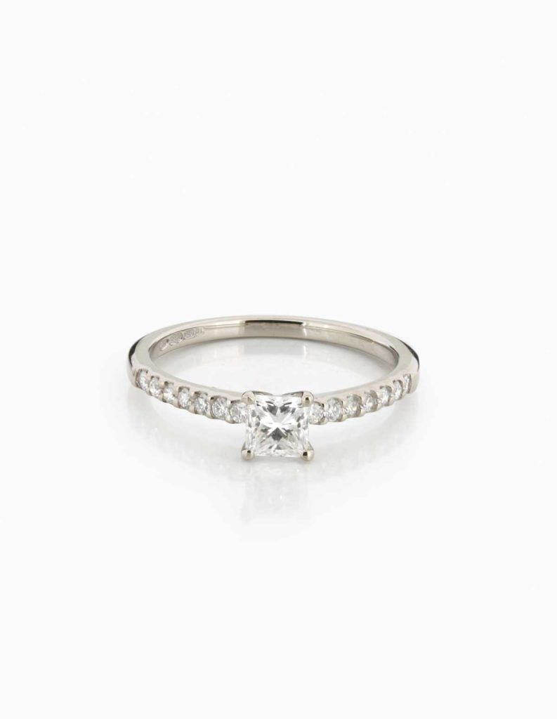 18ct white gold solitaire ring with a princess-cut diamond and pave diamond shoulders
