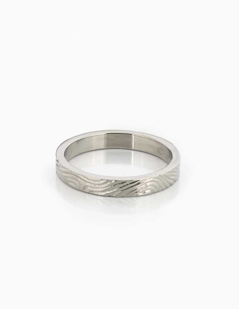 18ct white gold wedding band with a hand-engraved wavy textured finish
