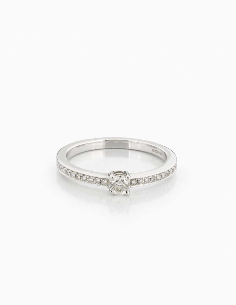 18ct white gold ring with a claw-set round diamond and pave diamond shoulders
