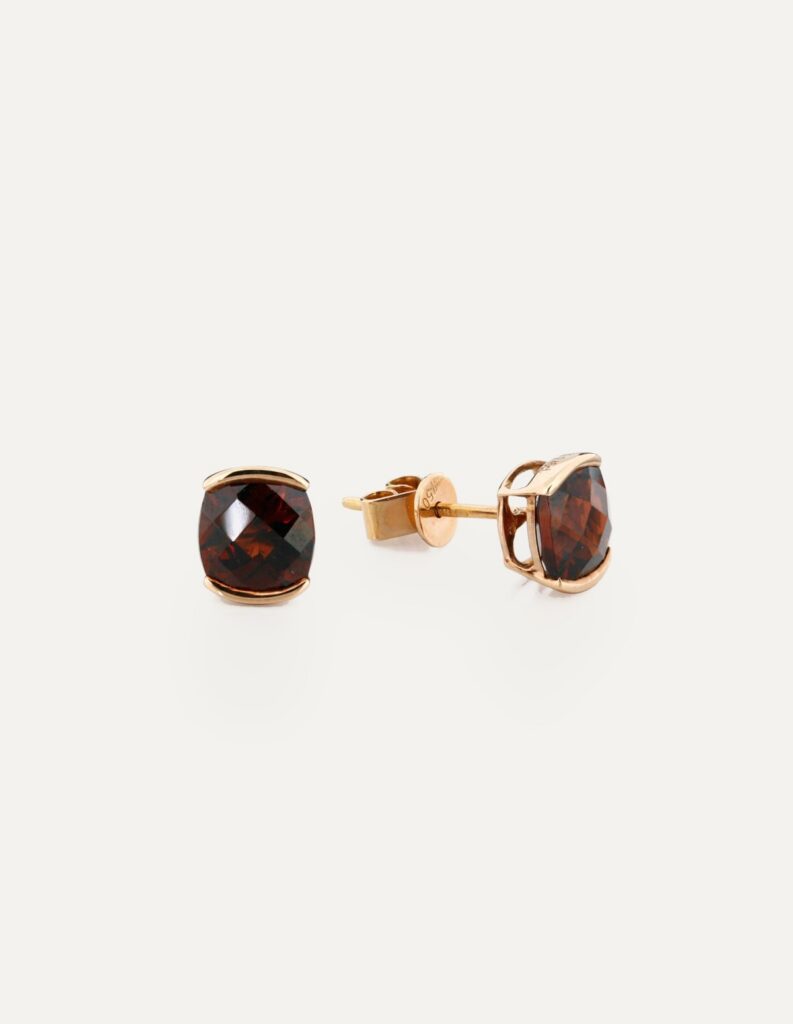 Pair of 18ct rose gold stud earrings with cushion-cut garnets, shown with the post and butterfly back
