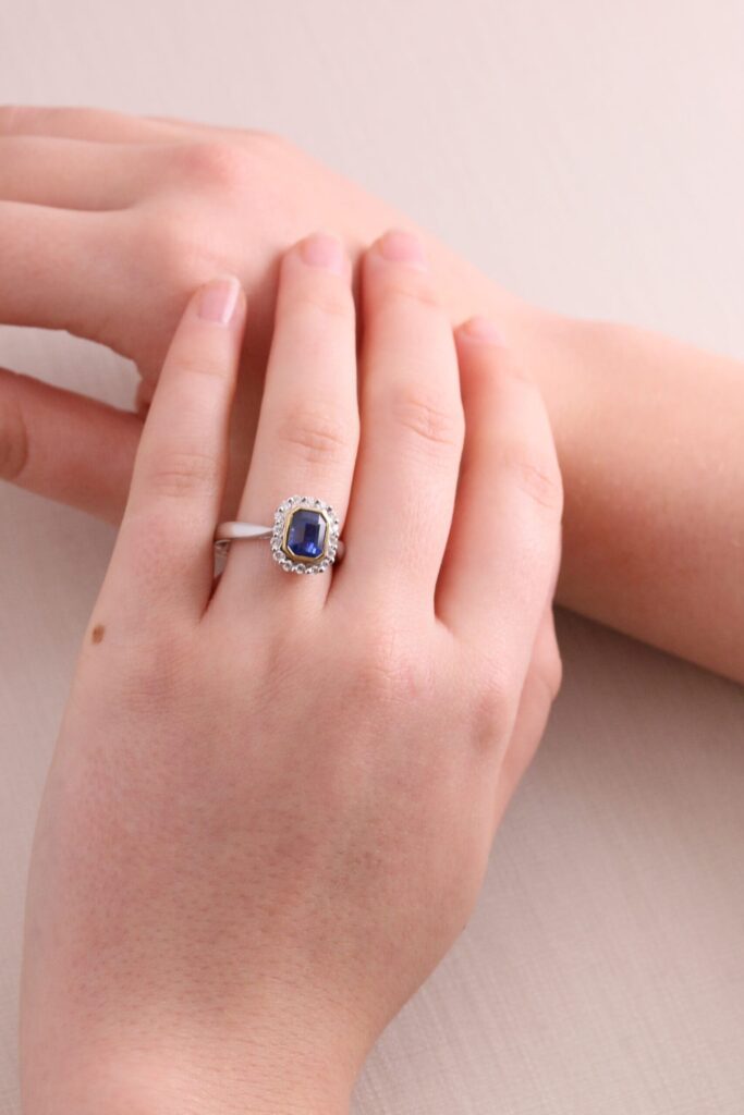 Dress ring cushion Sapphire 1.98ct in yellow gold bezel setting and diamond halo 0.26ct 18ct white gold ring size N