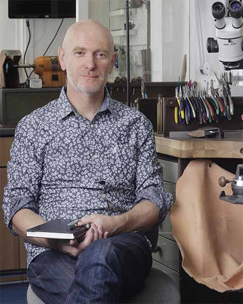 Goldsmith in front of bench