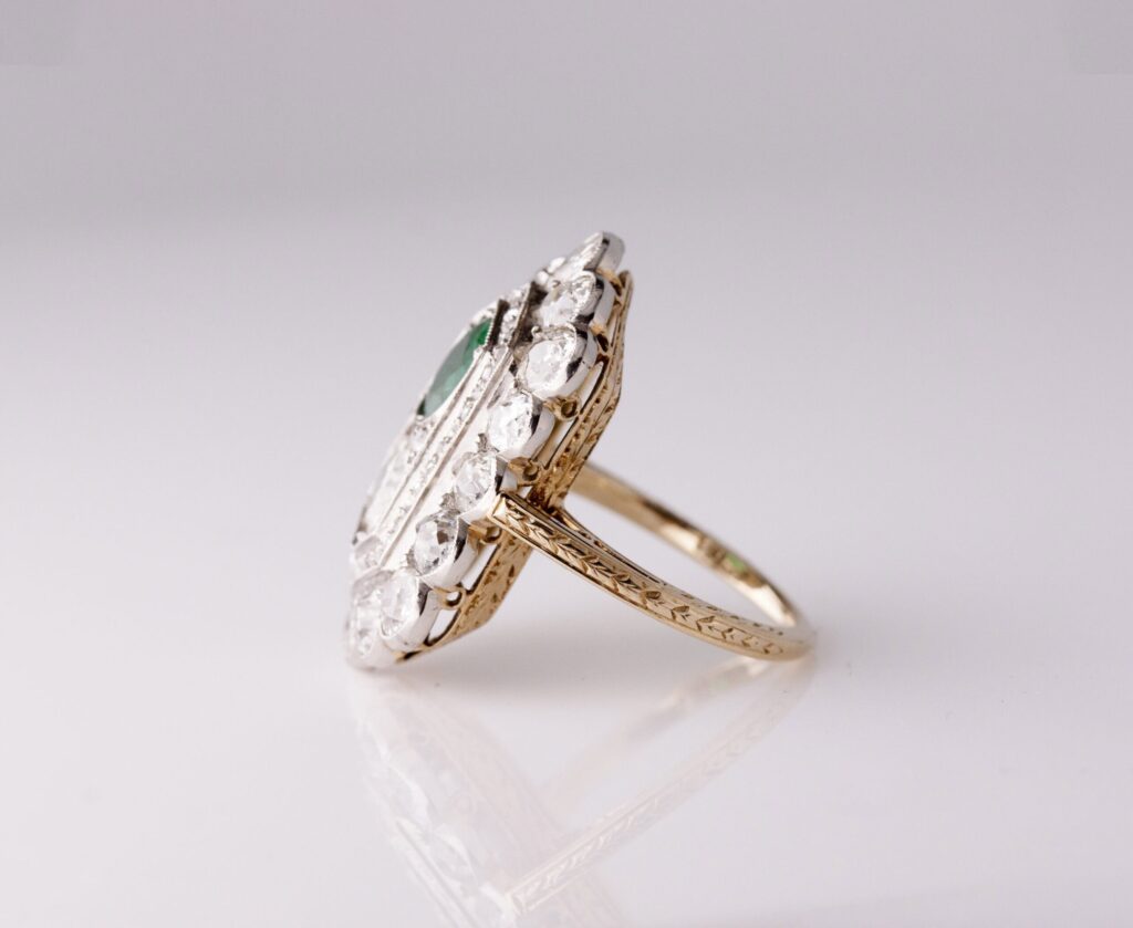 Sheild dress ring old european cut natural dia 0.90ct, 1 round mixed cut natural Emerald 0.90ct, 58 rose and old mine cut natural diamond halo 3.00cts, 7.65g, S12 clarity 18ct white and yellow gold ring size J1/2 — side view