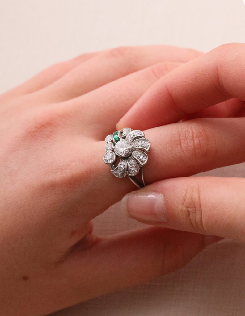 Dress ring fan design with round centre diamond 0.50ct other diamond details 0.76ct with smal emeralds 0.15ct platinum ring size N