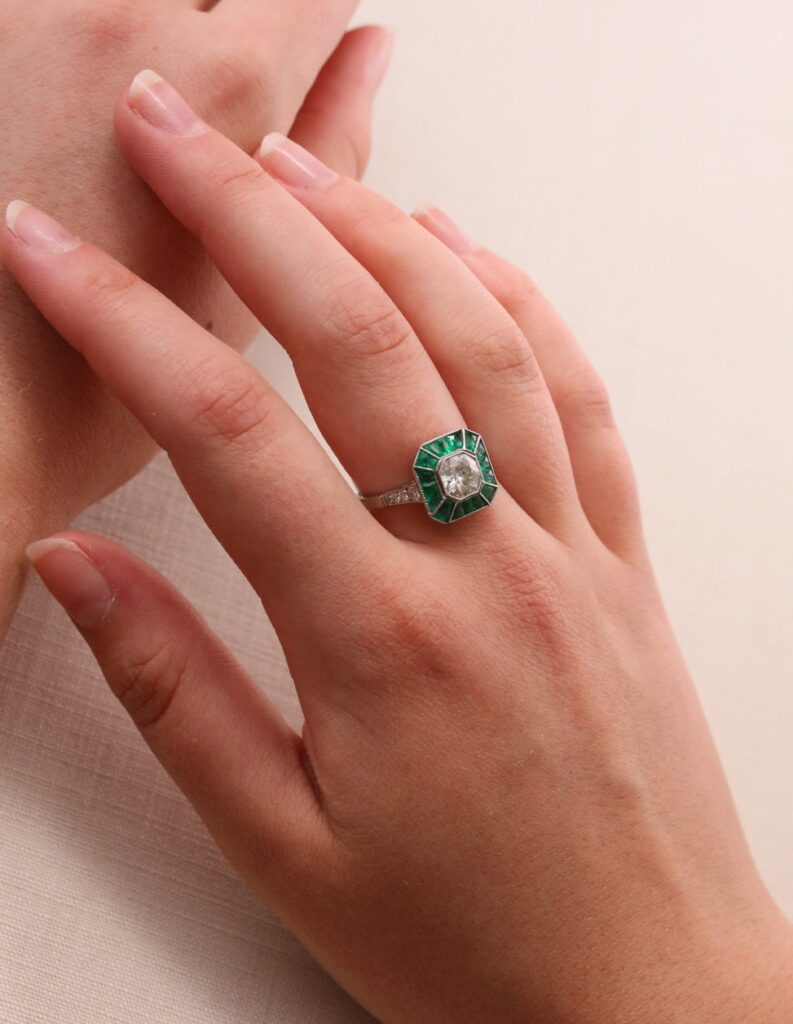 Dress ring art deco style centre roud diamond 1.30ct surrounded by Emeralds 0.90ct Platinum ring size O