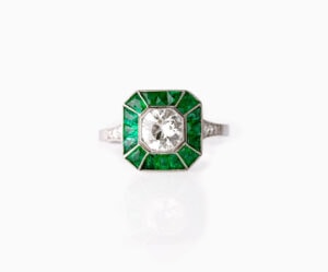 Dress ring art deco style centre roud diamond 1.30ct surrounded by Emeralds 0.90ct Platinum ring size O
