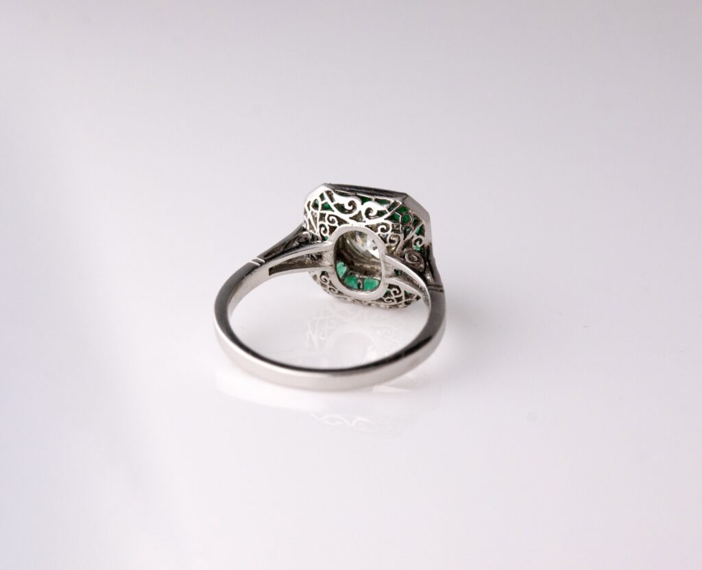 Dress ring art deco style centre roud diamond 1.30ct surrounded by Emeralds 0.90ct Platinum ring size O — back view