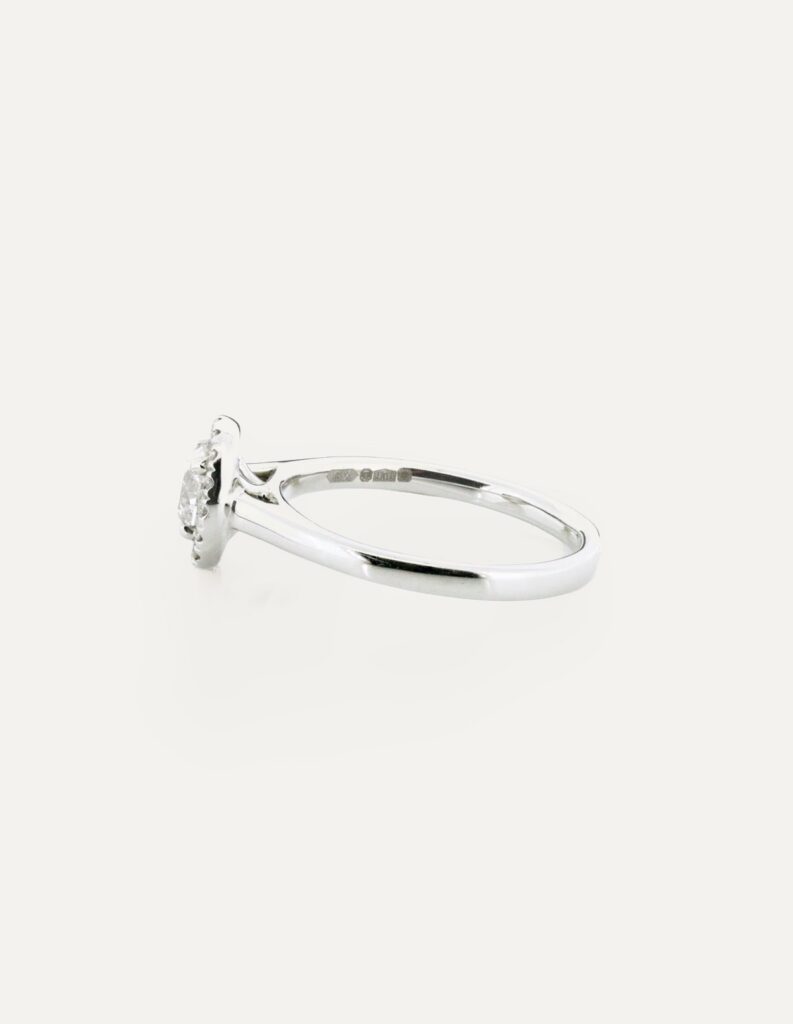 Halo round diamond ring centre four claw 0.62ct G/H SI halo 0.20ct platinum ring size N — side view