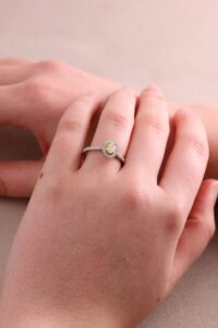 Halo oval ring fancy yellow diamond 0.31ct VS2 claw set diamond halo and shoulders 0.40ct fluted millgrain edge Platinum ring size M