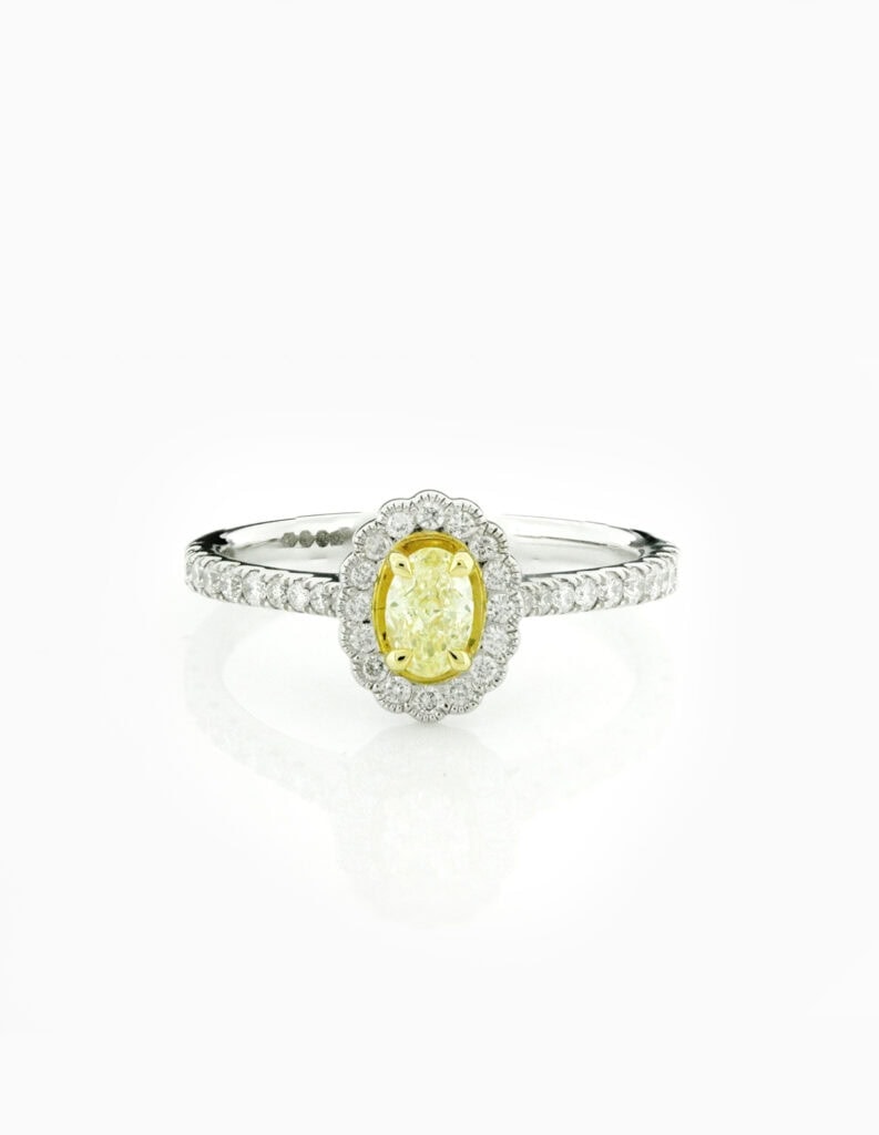 Halo oval ring fancy yellow diamond 0.31ct VS2 claw set diamond halo and shoulders 0.40ct fluted millgrain edge Platinum ring size M