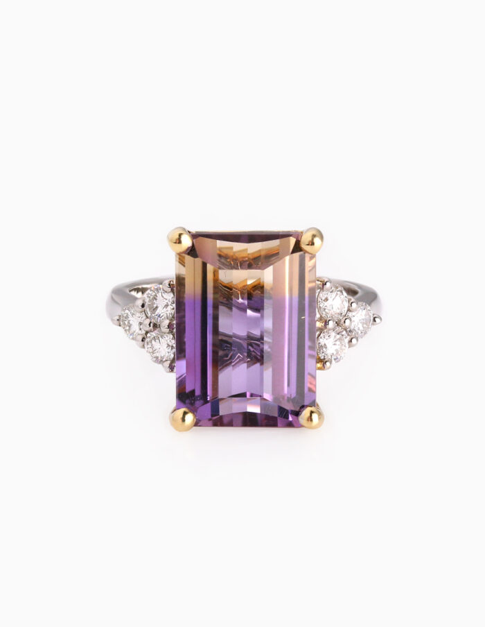 Large rectangular shaped purple and yellow stone with trefoil diamonds either side