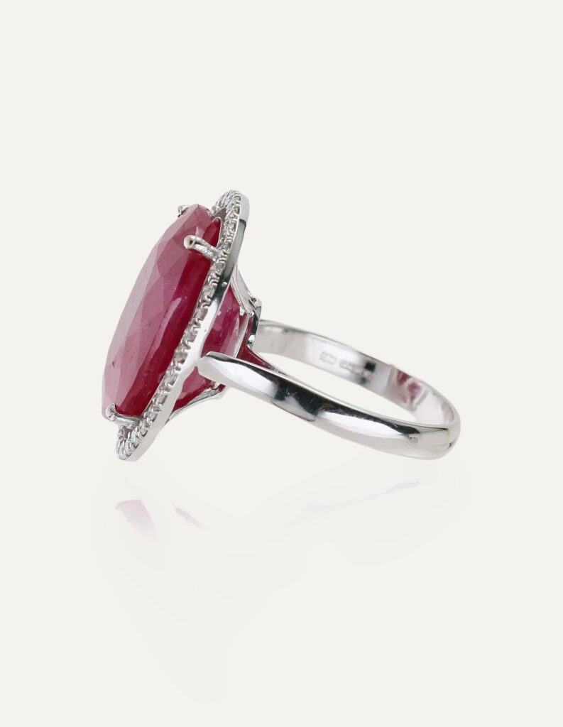Dress ring large oval ruby with diamond halo 18ct white gold ring size O — side view