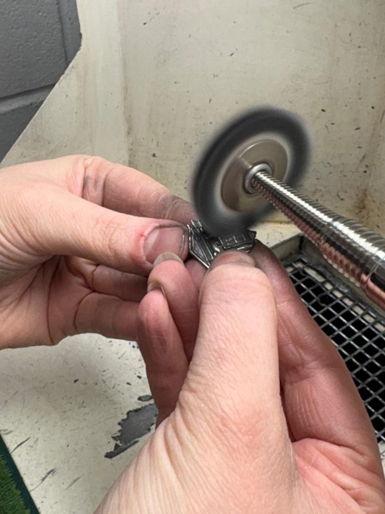 Polishing one of the mayoral chain insertions on the bench motor