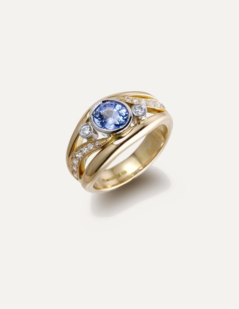One-off 9ct yellow gold ring with a cushion sapphire and diamond-set shoulders