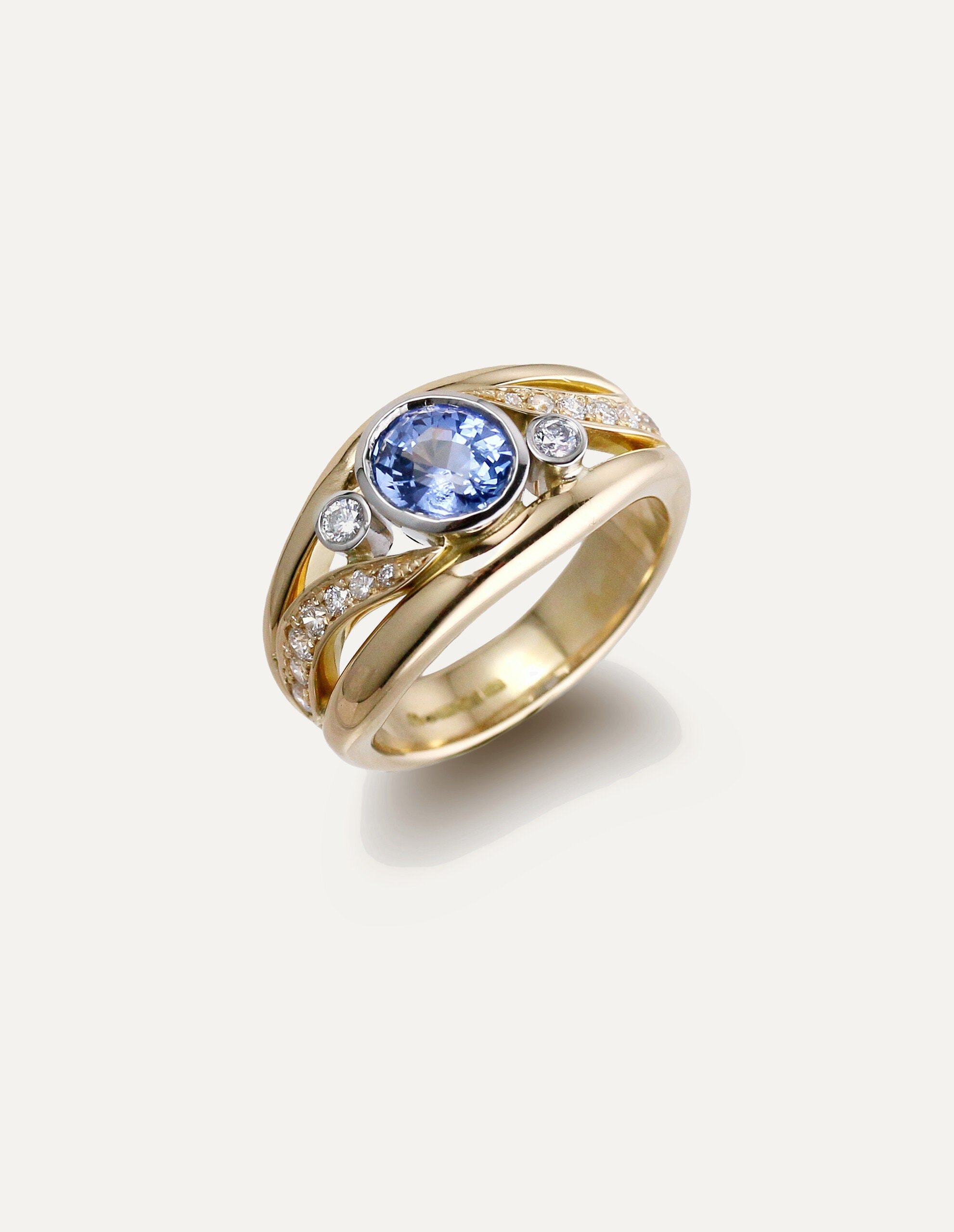 One-off 9ct yellow gold ring with a cushion sapphire and diamond-set shoulders