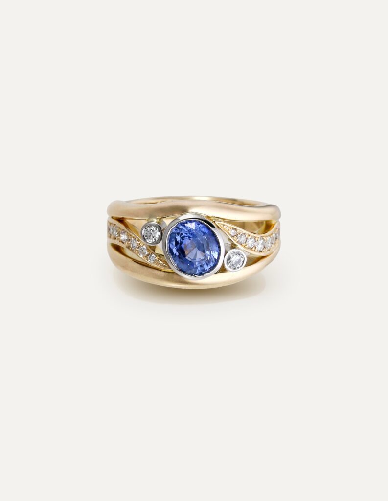 One-off 9ct yellow gold ring with a cushion sapphire and diamond-set shoulders
