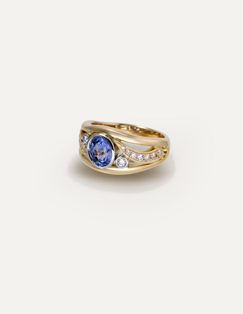 One-off 9ct yellow gold ring with a cushion sapphire and diamond-set shoulders