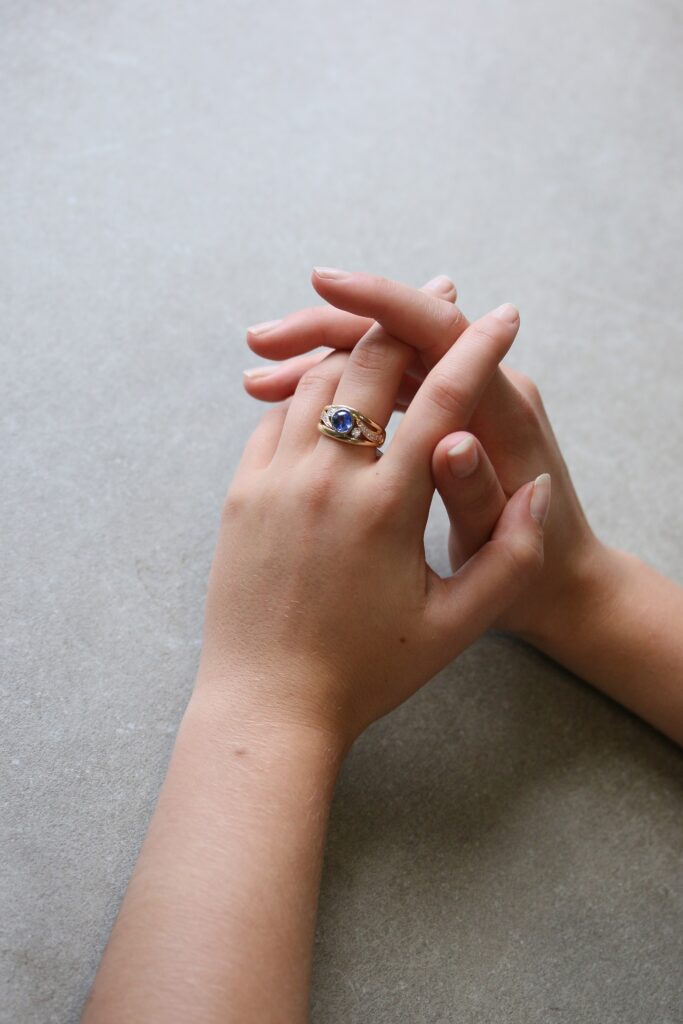 One-off 9ct yellow gold ring with a cushion sapphire and diamond-set shoulders