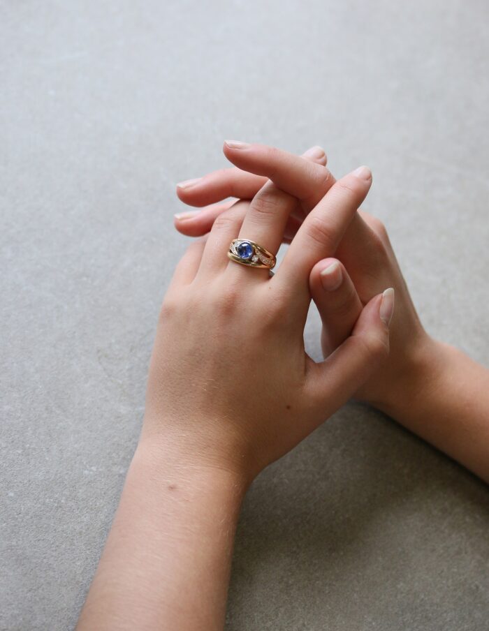 One-off 9ct yellow gold ring with a cushion sapphire and diamond-set shoulders