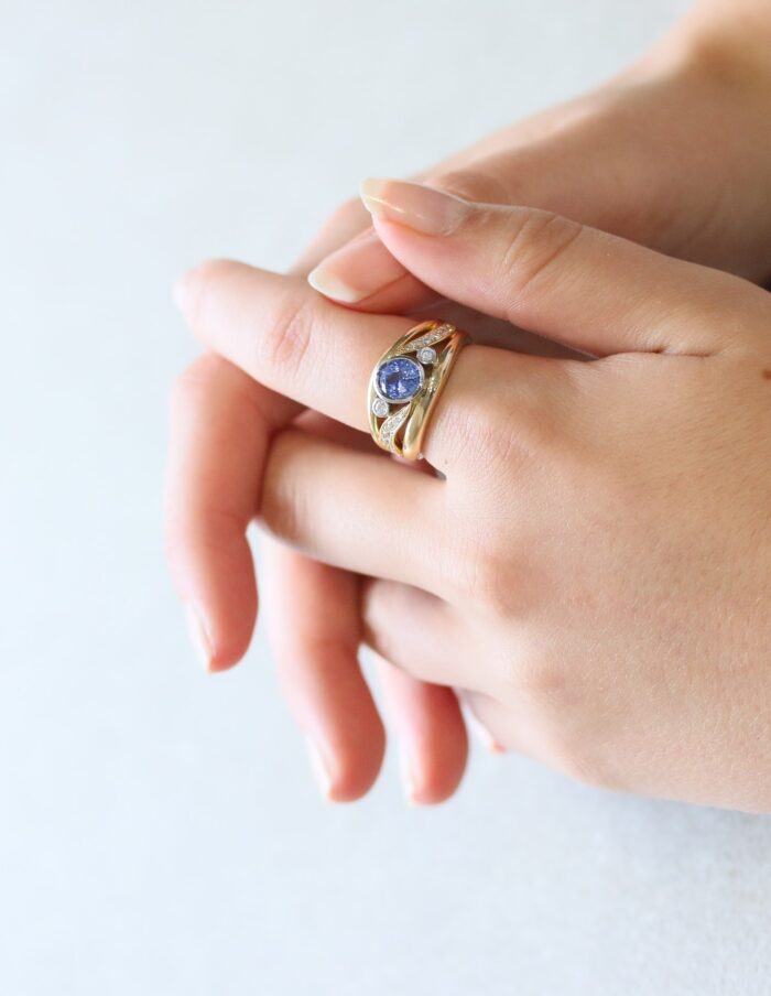One-off 9ct yellow gold ring with a cushion sapphire and diamond-set shoulders
