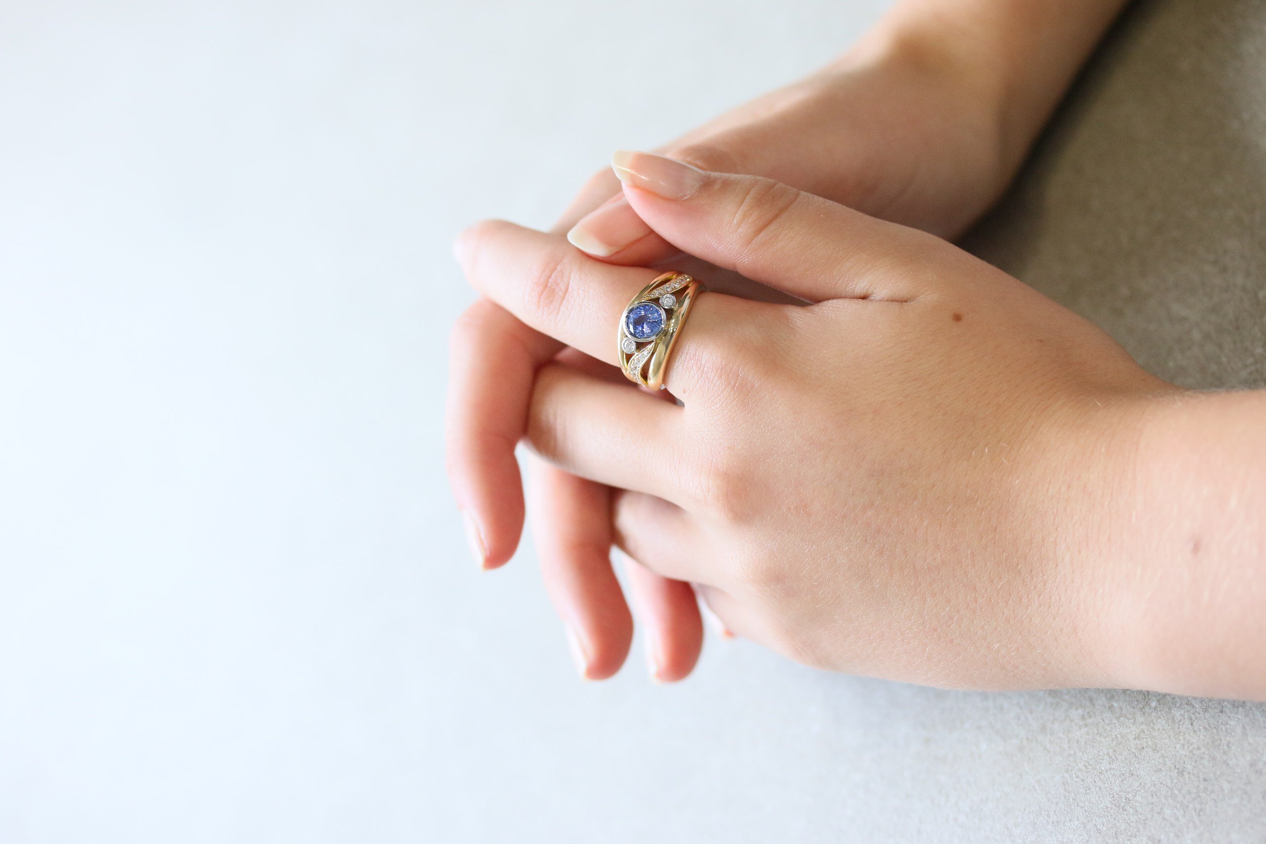 One-off 9ct yellow gold ring with a cushion sapphire and diamond-set shoulders