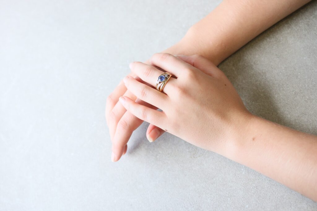One-off 9ct yellow gold ring with a cushion sapphire and diamond-set shoulders