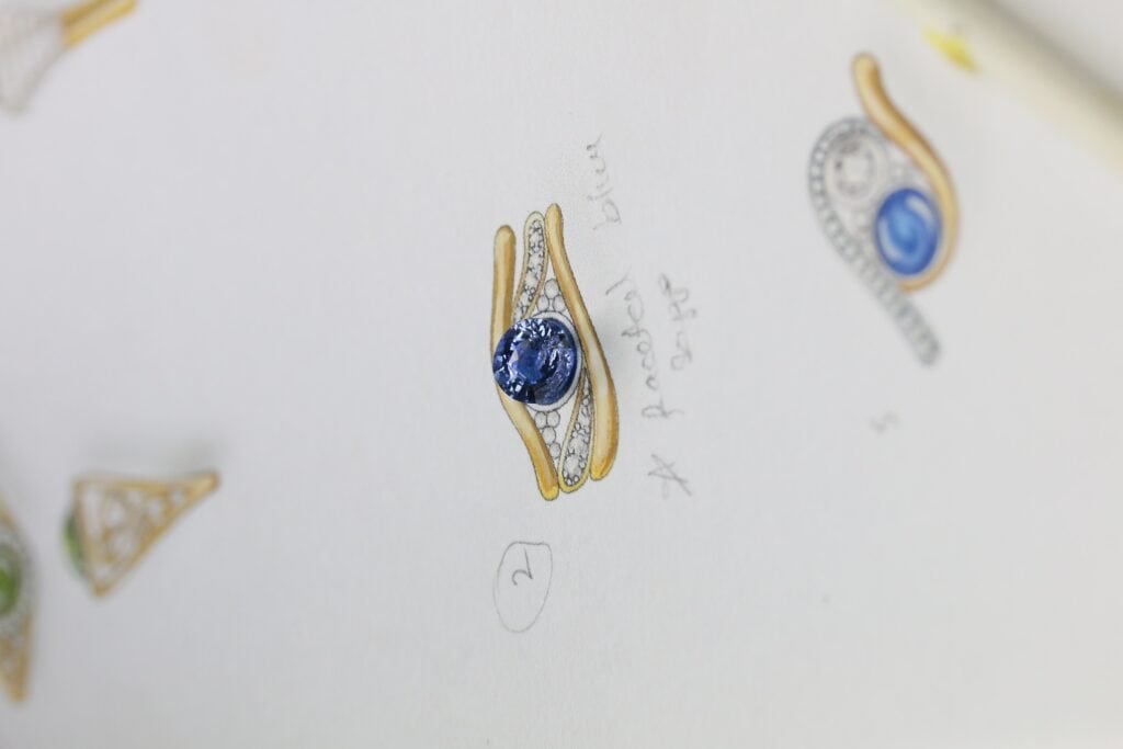 One-off 9ct yellow gold ring with a cushion sapphire and diamond-set shoulders
