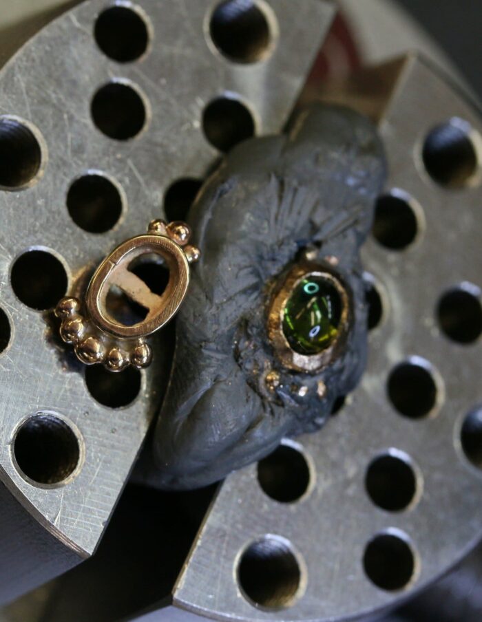 One-off green tourmaline cabochon stud earrings in 9ct yellow gold with bead-set bezels
