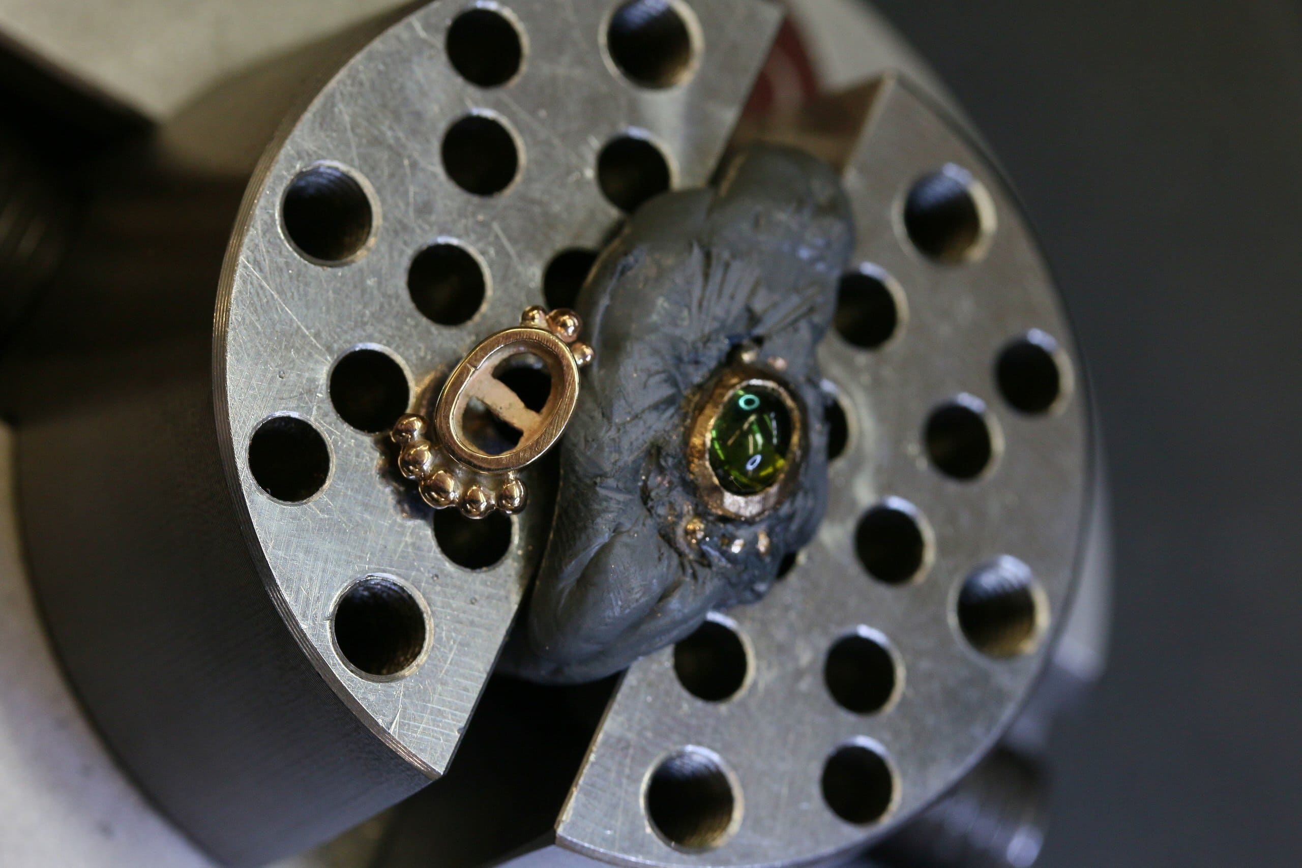 One-off green tourmaline cabochon stud earrings in 9ct yellow gold with bead-set bezels