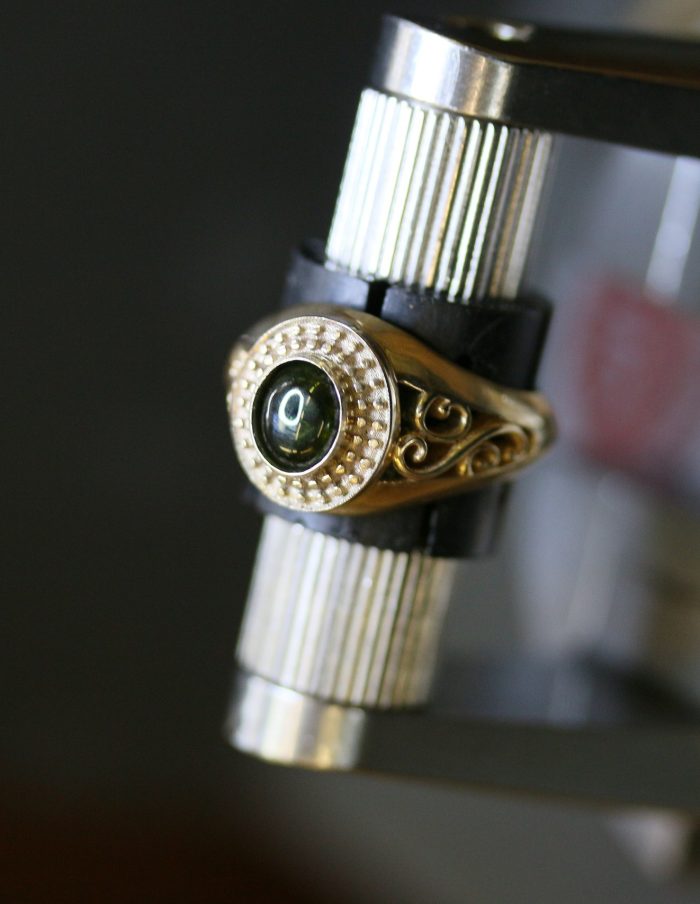 One-off 9ct gold signet ring with a green tourmaline cabochon in a diamond halo