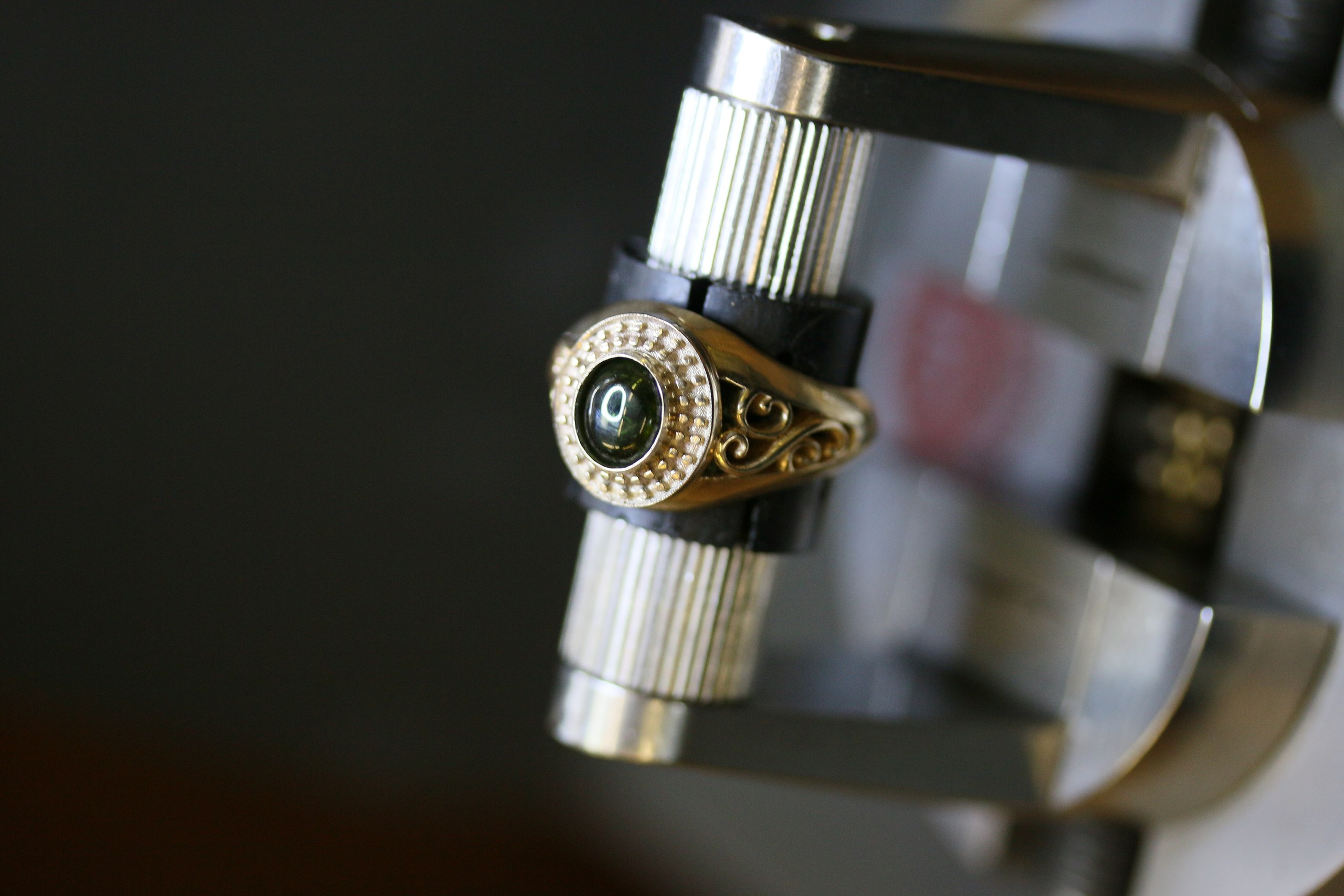 One-off 9ct gold signet ring with a green tourmaline cabochon in a diamond halo