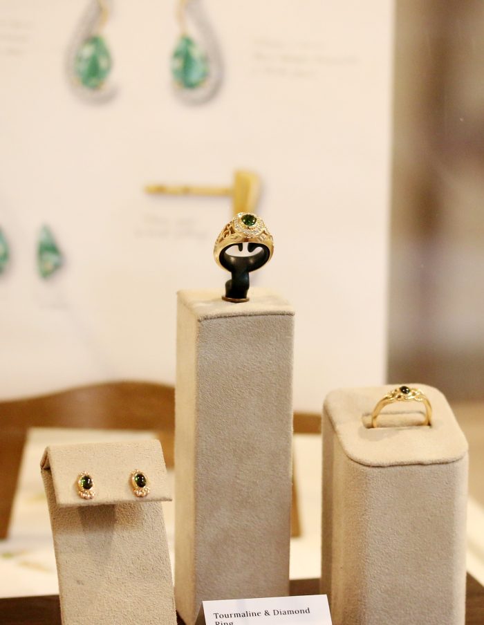 One-off 9ct gold signet ring with a green tourmaline cabochon in a diamond halo