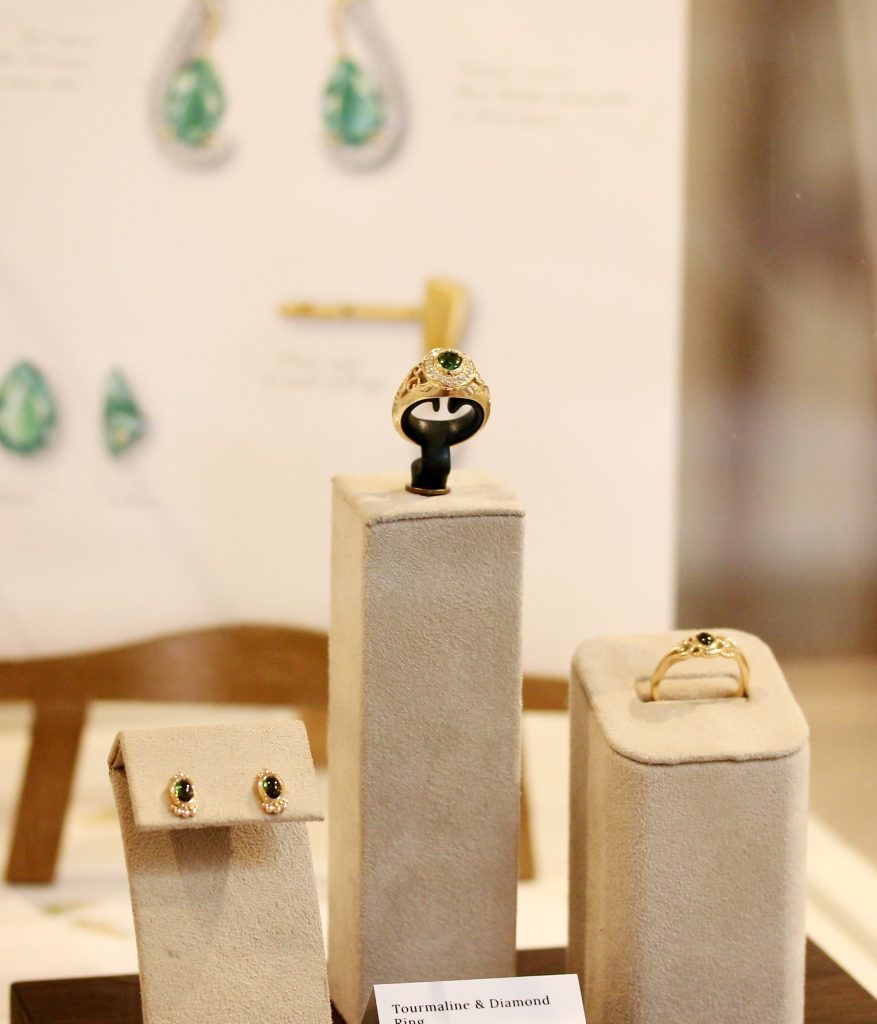 One-off 9ct gold signet ring with a green tourmaline cabochon in a diamond halo