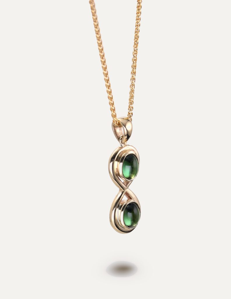 One-off 9ct gold infinity pendant set with two green tourmaline cabochons on a spiga chain