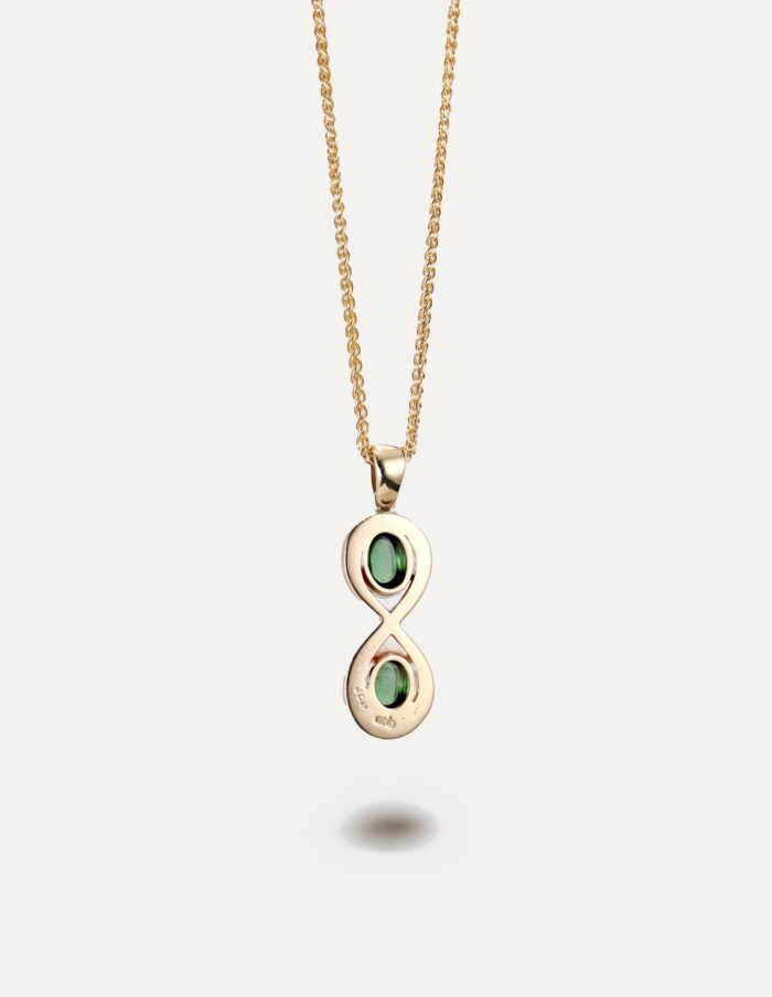 One-off 9ct gold infinity pendant set with two green tourmaline cabochons on a spiga chain