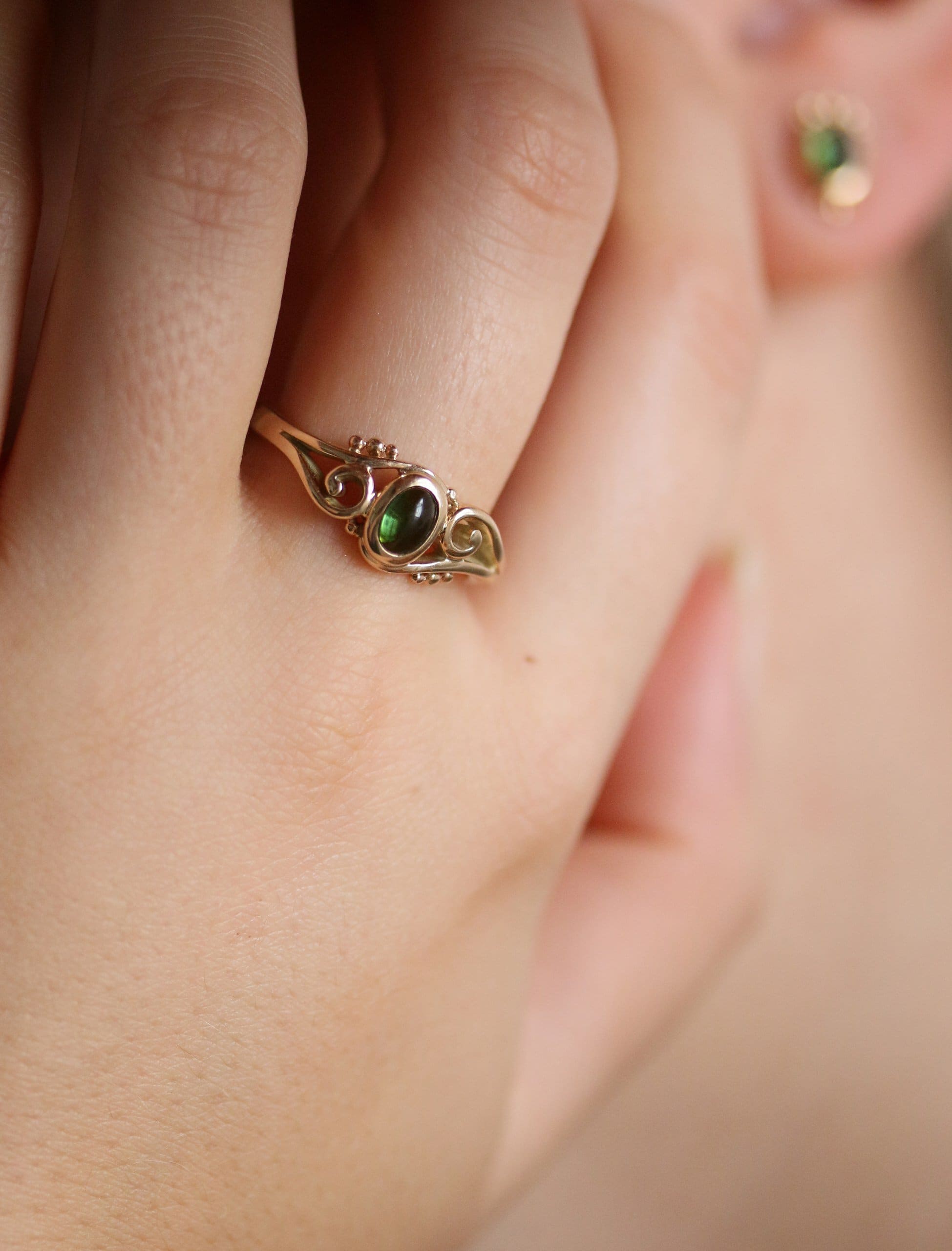 One-off 9ct gold swirl ring with a green tourmaline cabochon and applied gold beads