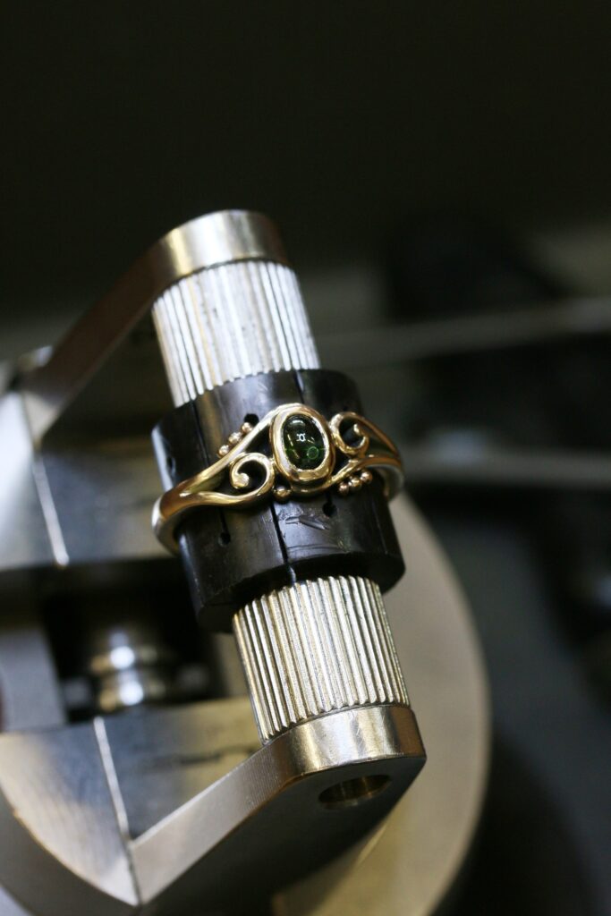 One-off 9ct gold swirl ring with a green tourmaline cabochon and applied gold beads