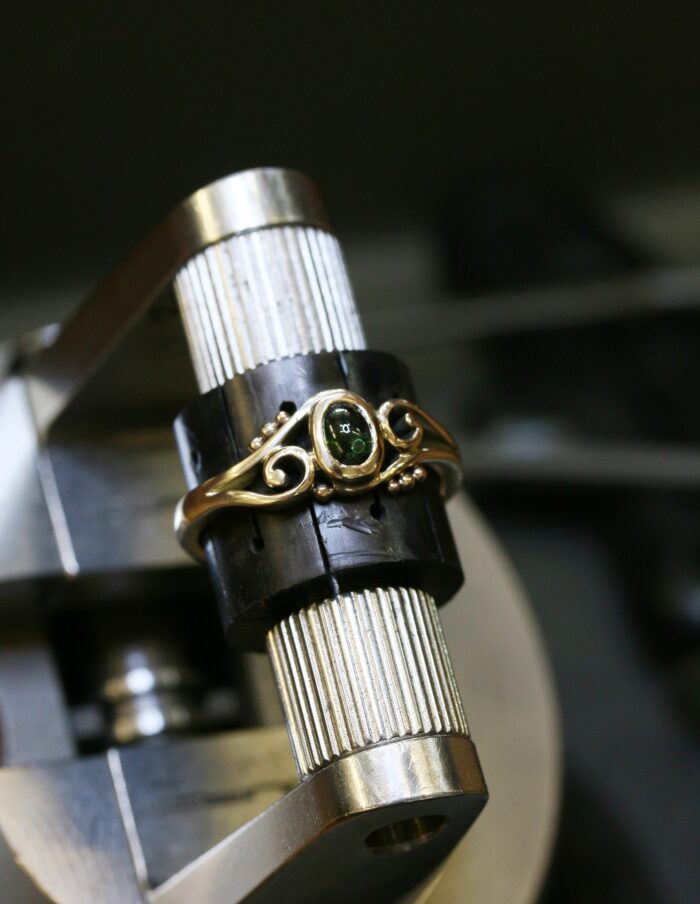 One-off 9ct gold swirl ring with a green tourmaline cabochon and applied gold beads