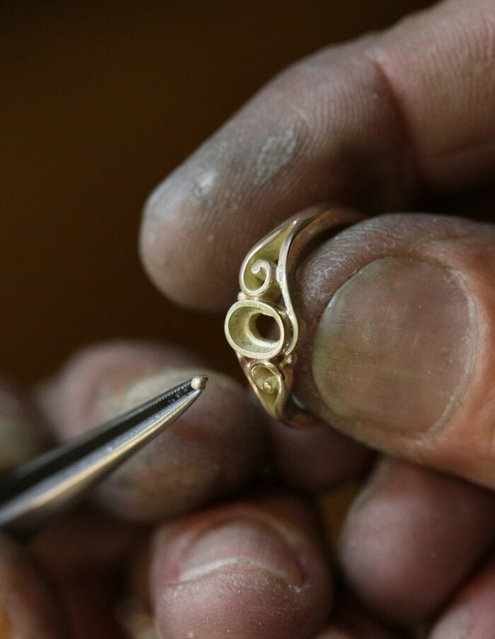 One-off 9ct gold swirl ring with a green tourmaline cabochon and applied gold beads