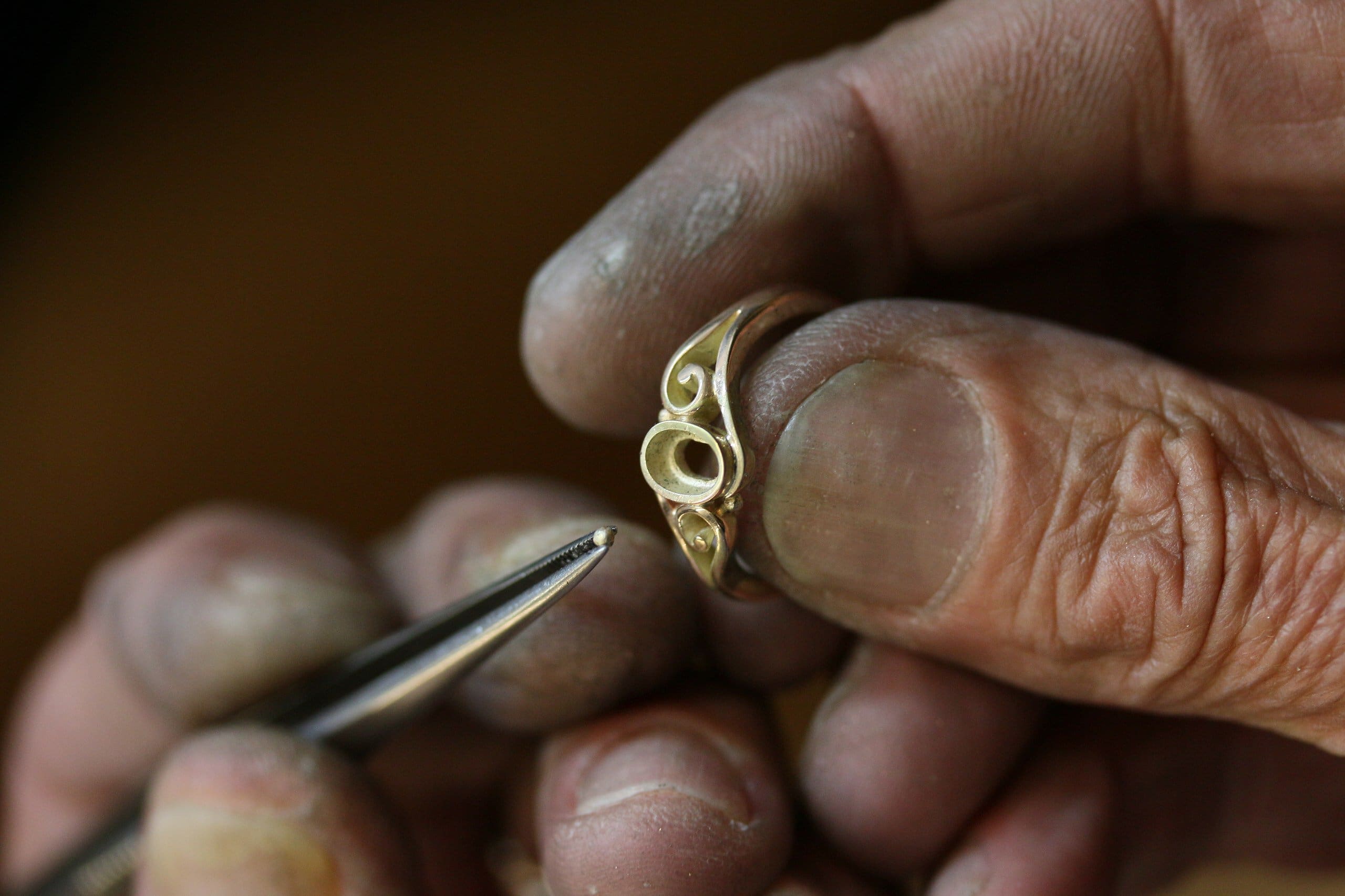 One-off 9ct gold swirl ring with a green tourmaline cabochon and applied gold beads